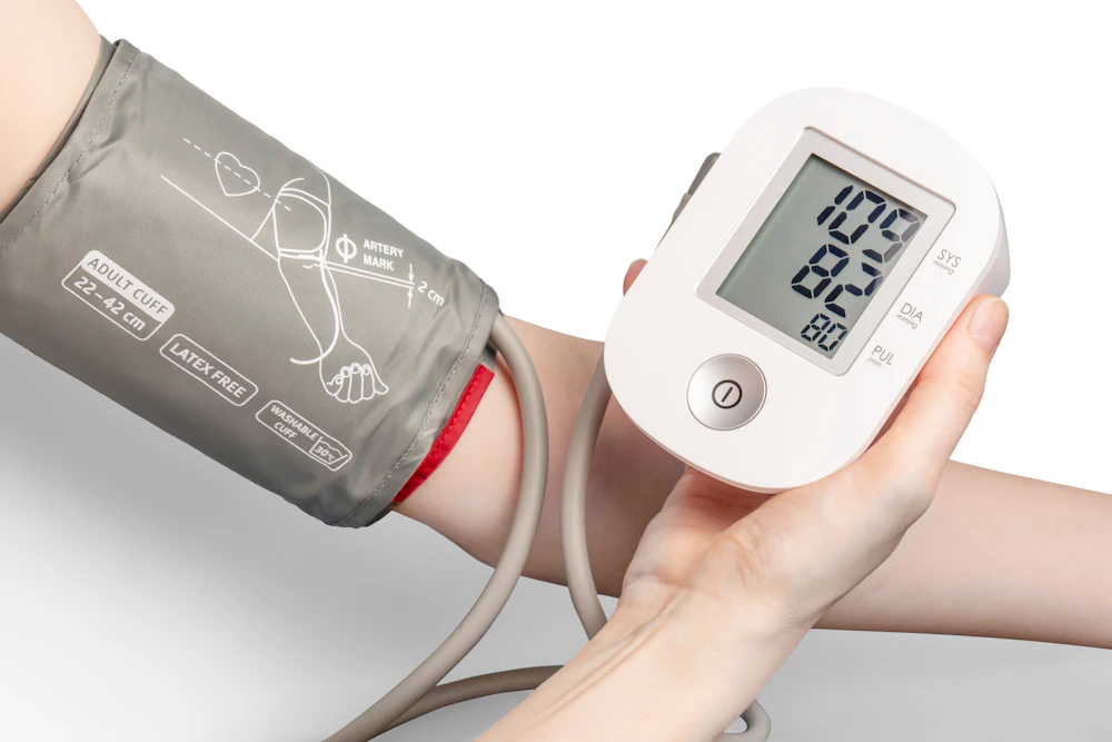 Digital blood pressure monitor with a cuff on a person's arm