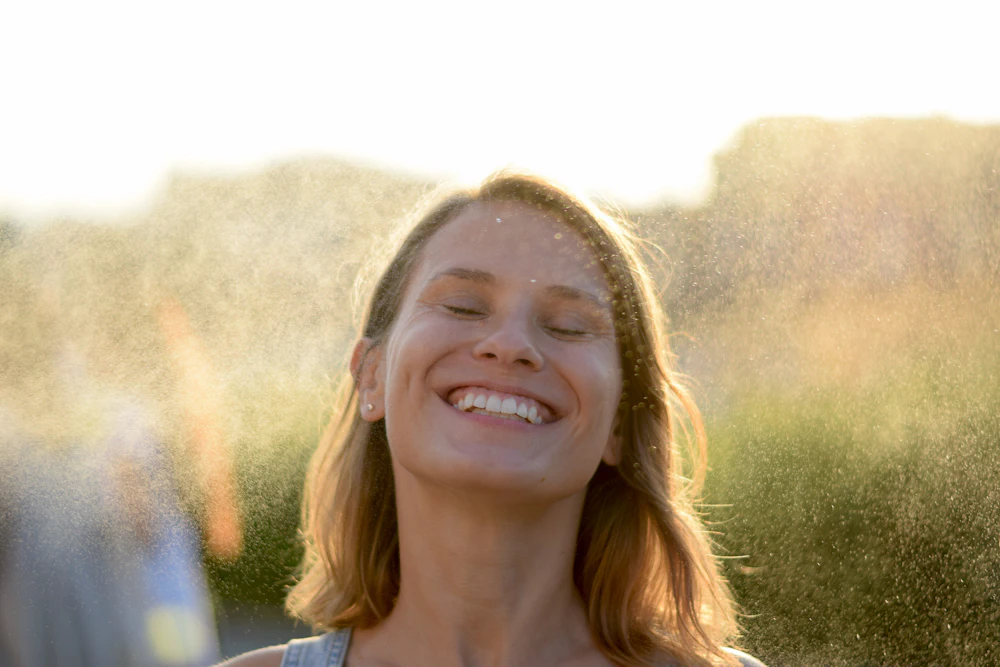 Smiling woman enjoying the sunshine outdoors